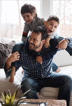 Father plays with his two young sons