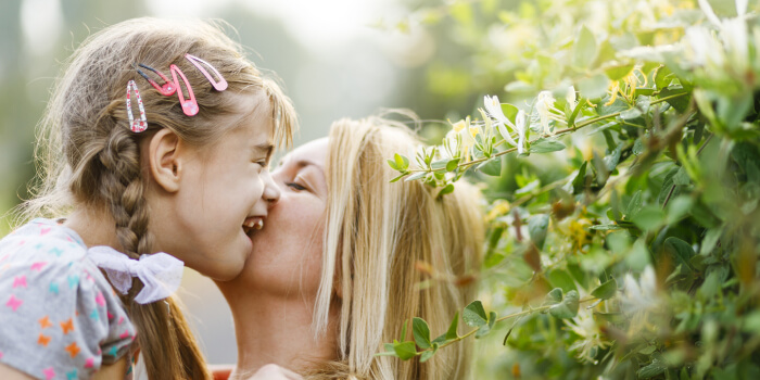 mother embracing young special needs daughter