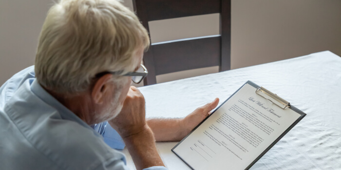 older man reviewing will pensively