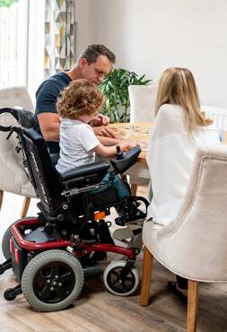 young parents with special needs son in wheelchair