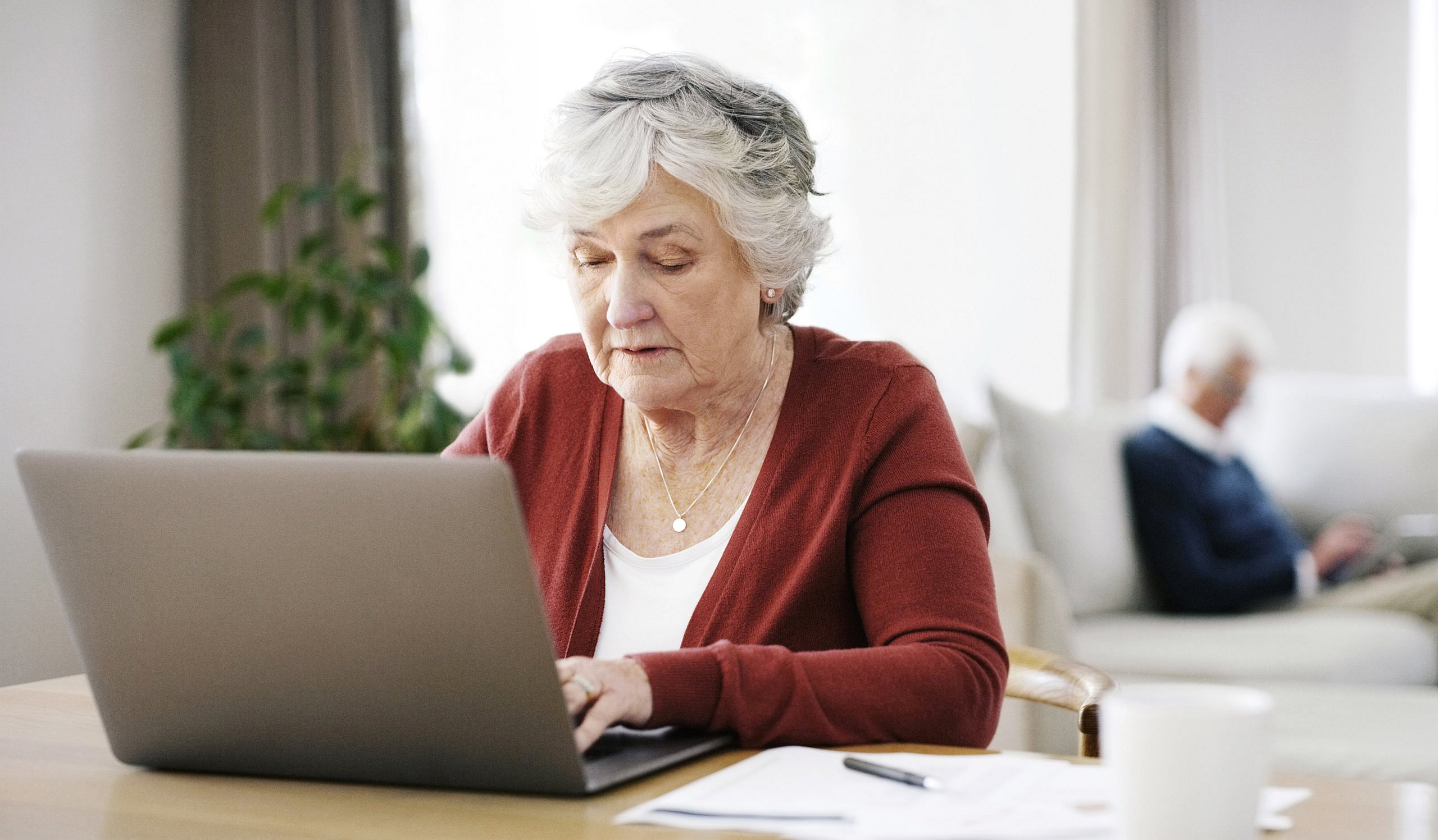 Elderly woman planning her estate online during pandemic.