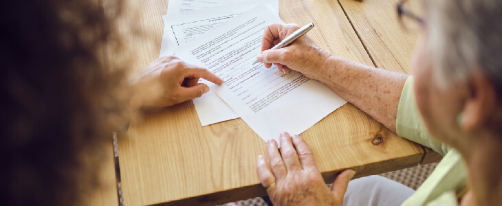 elderly woman listing her child's guardian on a legal document