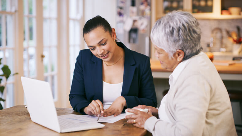 Young woman helping older woman with her estate plan