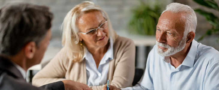 Older man and woman sitting with estate planning attorney