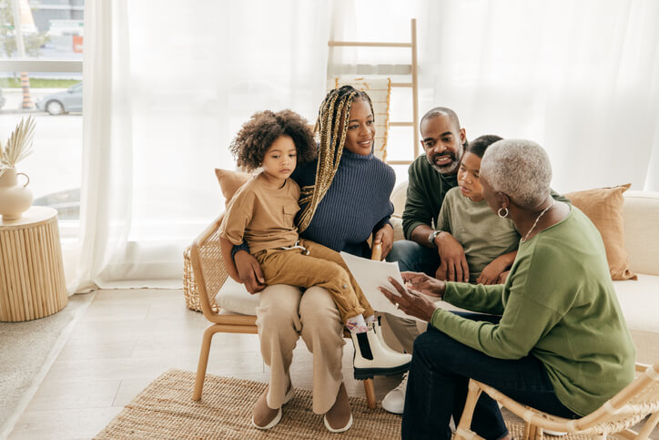 Parents sitting with children and estate planning attorney