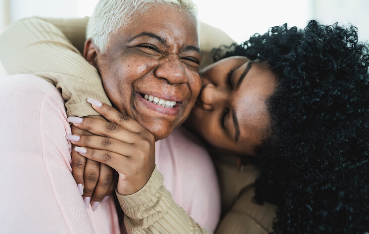 caregiver embraces senior mother