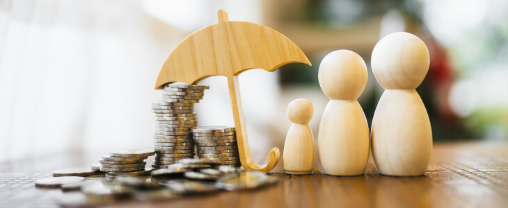 Cut out of an umbrella with coins and wooden figurines