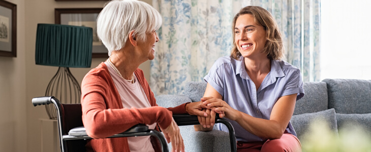 Woman visiting elderly mother in an assisted living facility