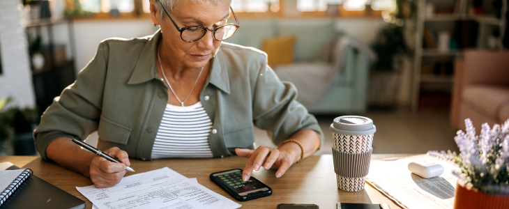 Older woman looking over retirement account documents