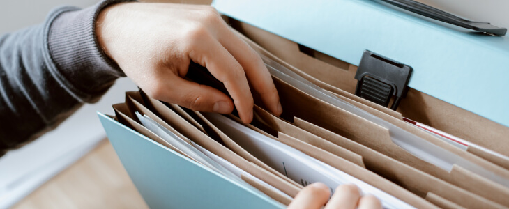 Man organizing files in a binder
