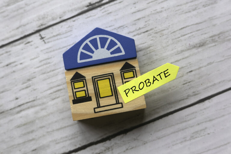 Wooden toy house with a sticker on it reading PROBATE