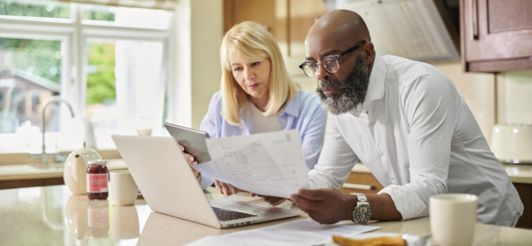 Seniors at home reviewing tax documents