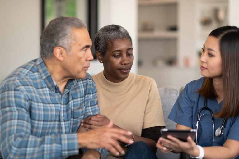 middle aged couple speaking to a medicaid nurse