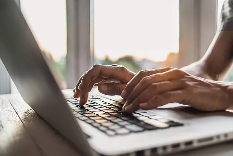 Woman on a computer managing her digital assets.