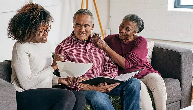 Elderly couple sitting with daughter