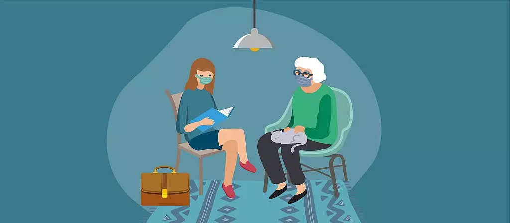 A person wearing a mask sitting with an attorney who is also wearing a mask