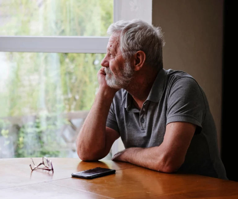 Older man sitting alone