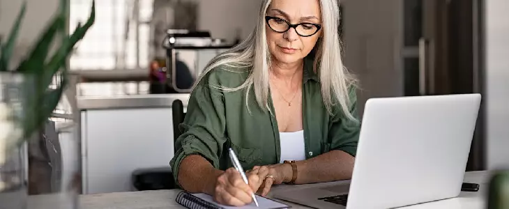 female on her laptop looking up Secure Act