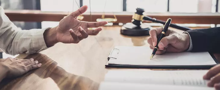 man listing his beneficiaries to his lawyer