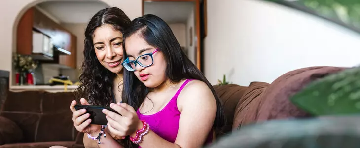 mother teaching her special needs daughter