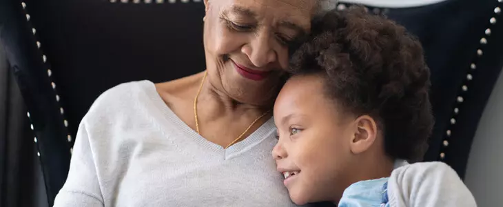 elderly woman hugging her granddaughter
