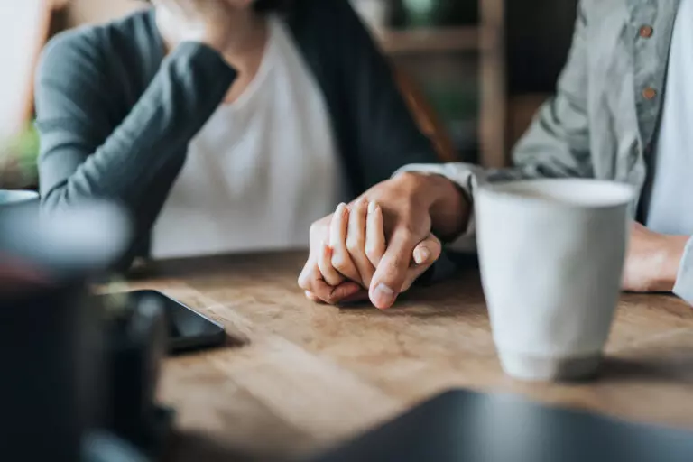 widow holding hands with man.