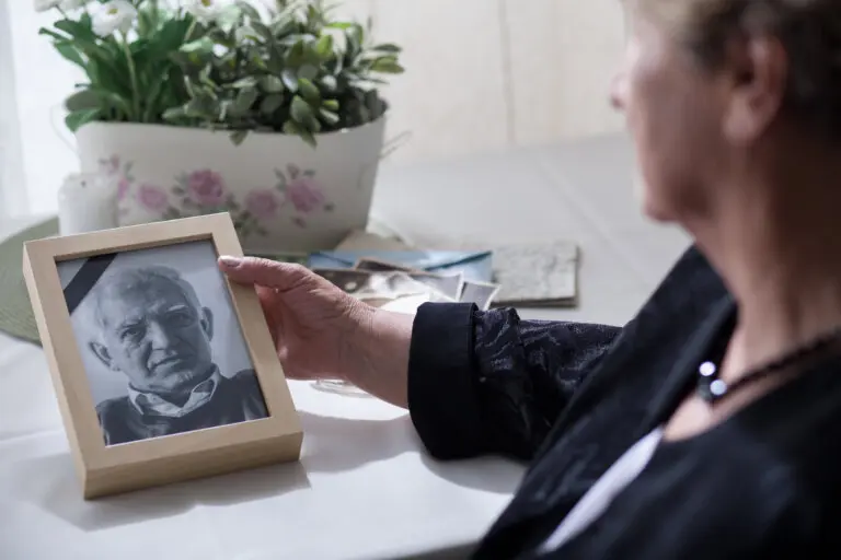 widow looking at photo of husband