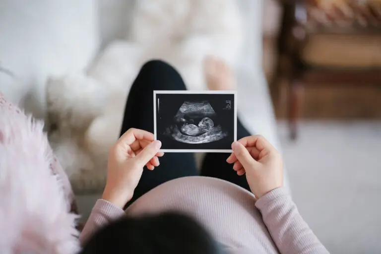 woman looking at photo of baby