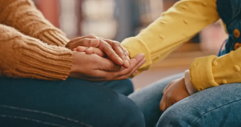 woman holding daughter's hand
