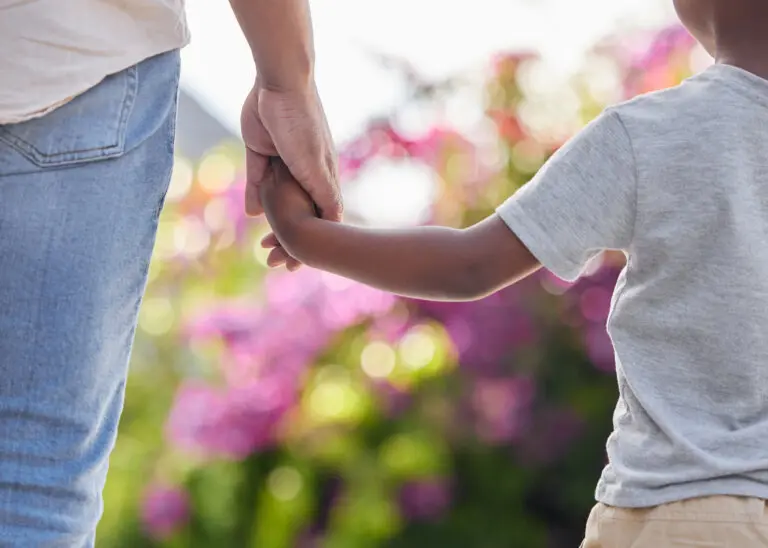 son and mother holding hands