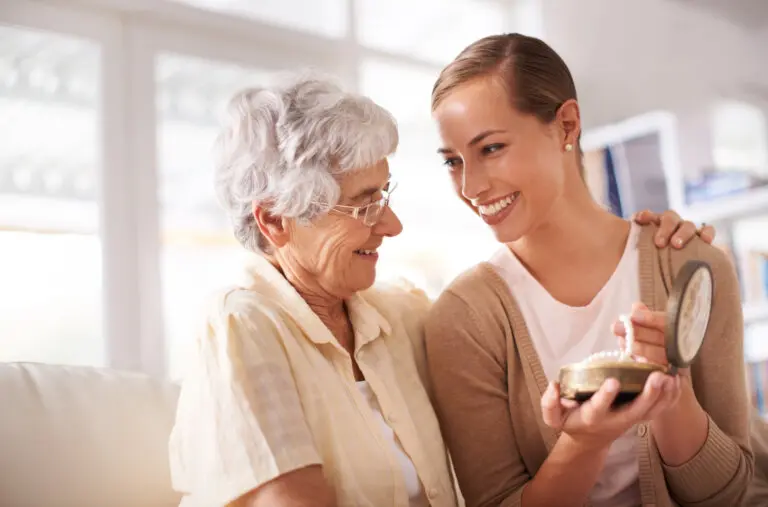 grandmother giving granddaughter heirloom