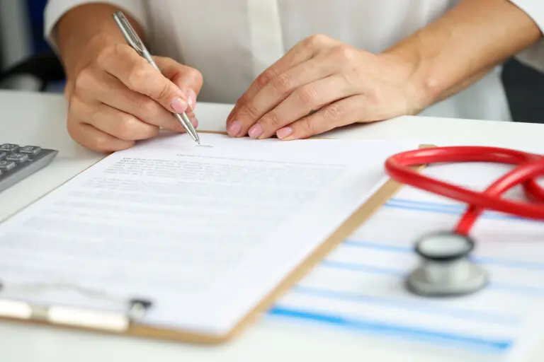 woman signing estate planning document
