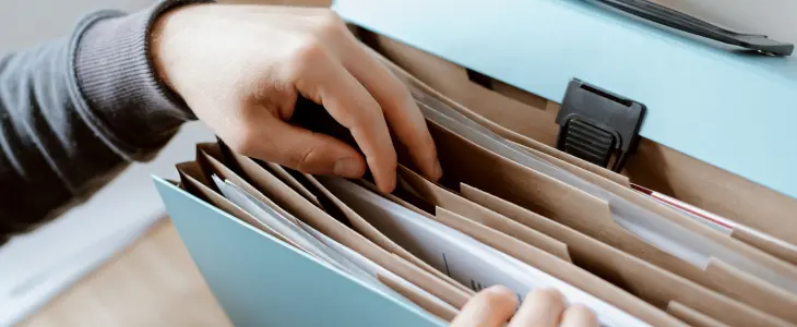 Man organizing files in a binder