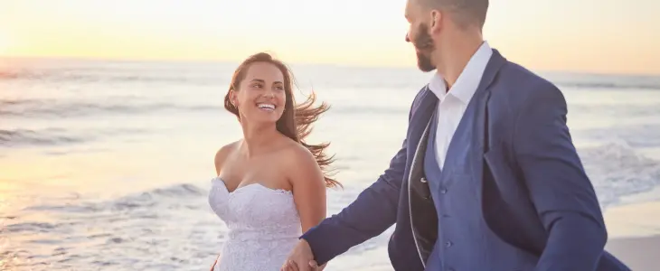 Newlyweds walking on a beach