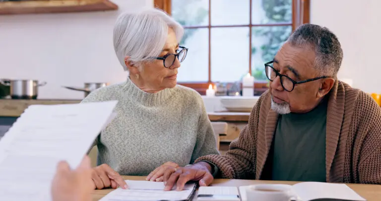 Elderly couple reviewing documents