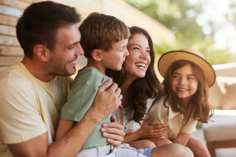 Happy parents smiling with their small kids