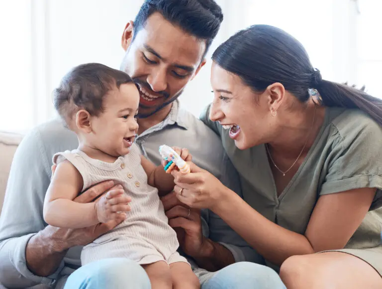 young couple playing with their baby girl