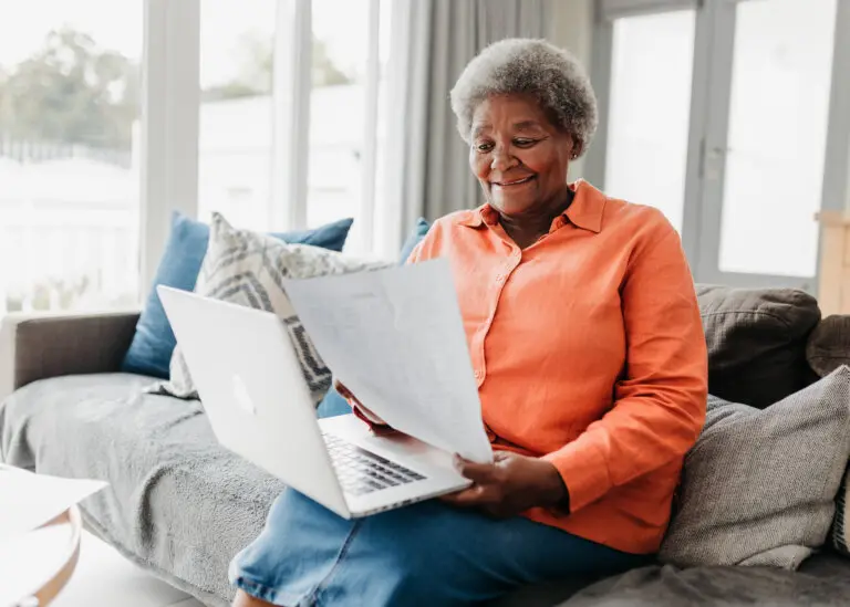 Senior woman smiling and preparing estate planning document