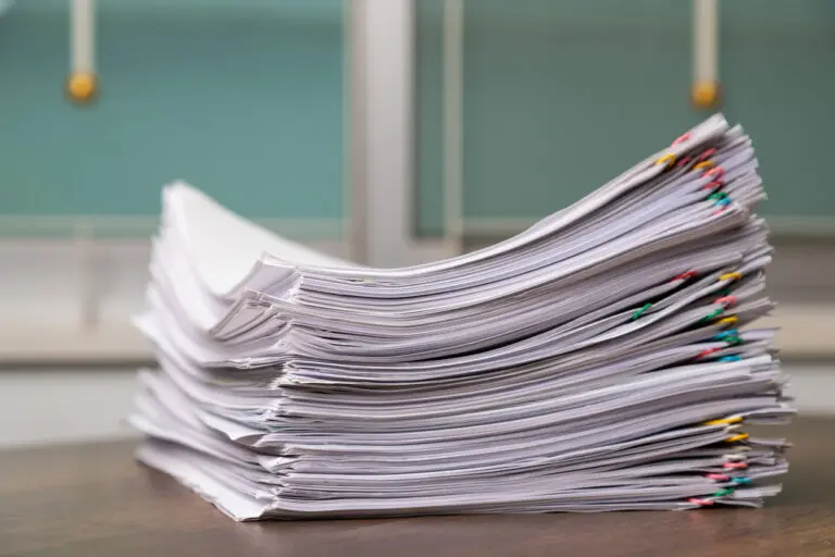 Stack of overload document paper on the table.
