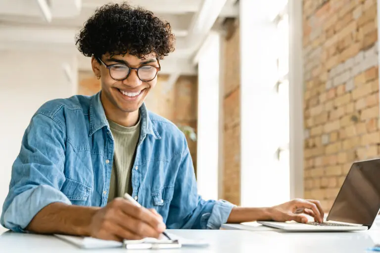 Confident young mixed-race businessman working at the office desk