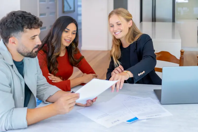 agent with couple looking through documents