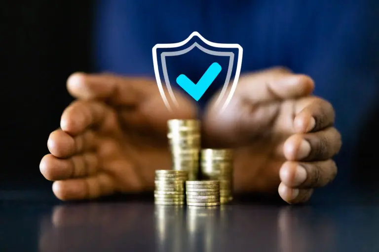 stack of. coins and shield digital graphic with person's hands cupped around them