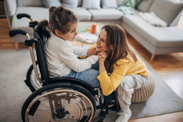 Mother and young daughter who is in wheelchair